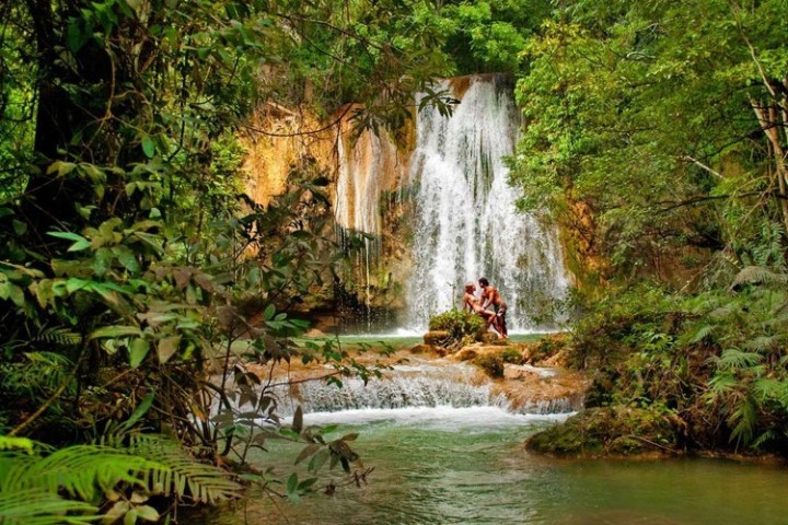 a large waterfall over a body of water